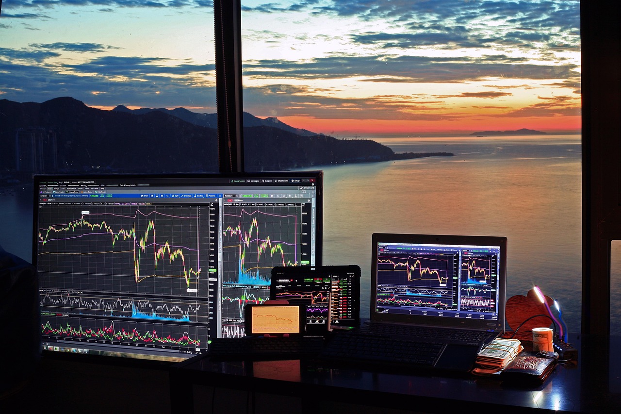 Multiple monitors at a trader's desk — steam chase requires the same setup