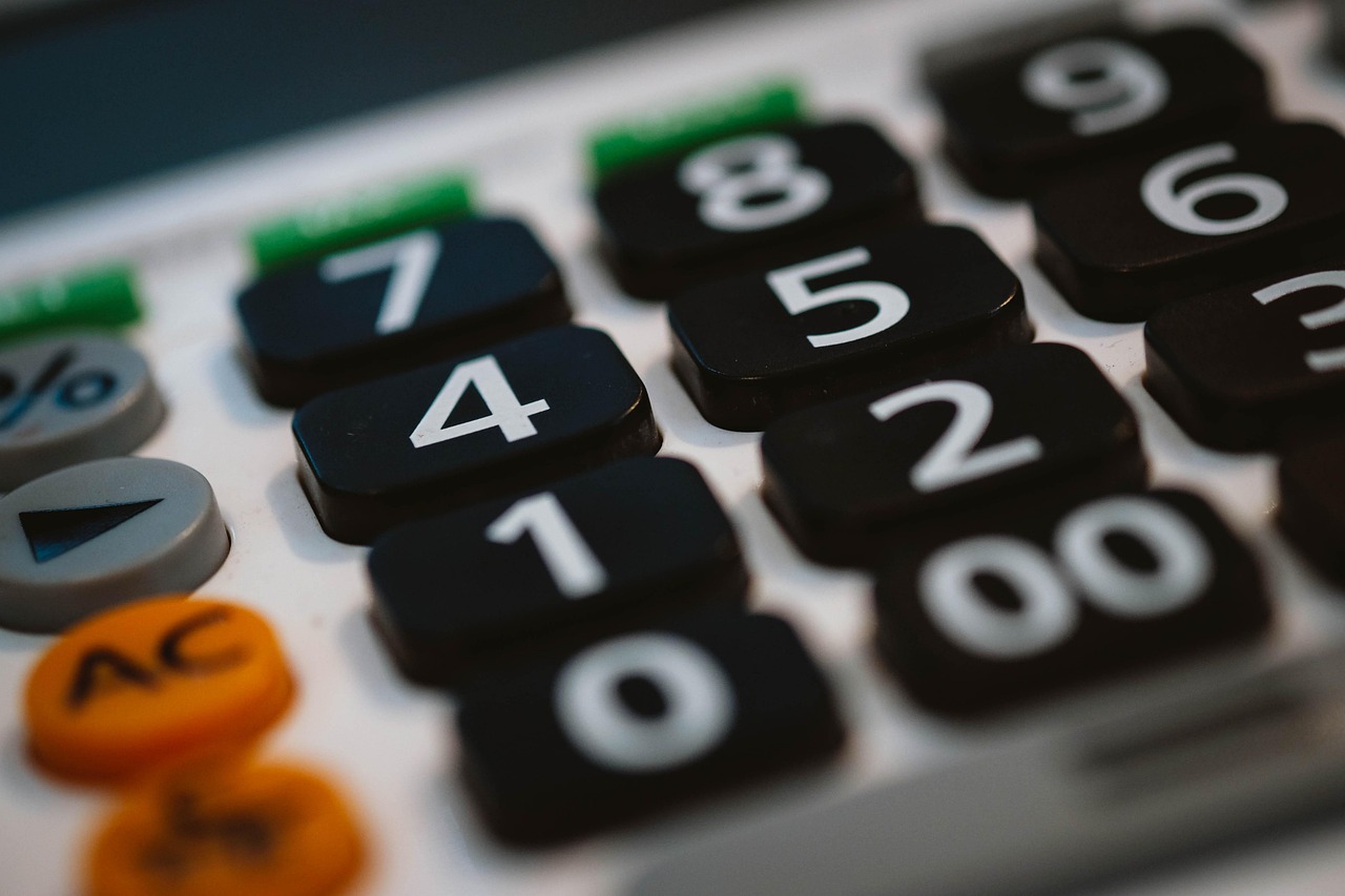 Calculator with financial documents — vig is the math behind every sportsbook price